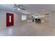 Open-concept living area and kitchen with white cabinets, granite counters, and red front door at 2148 W Hayward Ave, Phoenix, AZ 85021