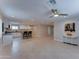 Open-concept living area with kitchen featuring white cabinets and granite countertops at 2148 W Hayward Ave, Phoenix, AZ 85021