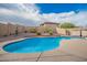 Backyard with a pool surrounded by desert landscaping at 22672 W Solano Dr, Buckeye, AZ 85326