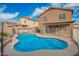 Backyard view showcasing a refreshing pool, patio area, and lush landscaping, ideal for outdoor enjoyment at 22672 W Solano Dr, Buckeye, AZ 85326