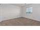 Bedroom featuring neutral carpeted floors, white walls, and a window providing natural light at 22672 W Solano Dr, Buckeye, AZ 85326