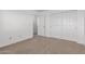Bedroom featuring neutral carpeted floors, white walls and a closet with sliding doors at 22672 W Solano Dr, Buckeye, AZ 85326