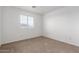 Bedroom with carpeted floor, a bright window allowing natural light in at 22672 W Solano Dr, Buckeye, AZ 85326