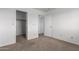 Bedroom featuring neutral carpeting, access to the closet and bathroom at 22672 W Solano Dr, Buckeye, AZ 85326