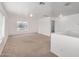 Upstairs bonus room filled with light, plush carpet, and neutral paint at 22672 W Solano Dr, Buckeye, AZ 85326