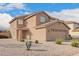 Exterior view of a two-story home with desert landscaping and a two-car garage at 22672 W Solano Dr, Buckeye, AZ 85326