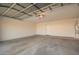 Spacious garage featuring concrete flooring, overhead door, and room for vehicle parking and storage at 22672 W Solano Dr, Buckeye, AZ 85326
