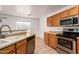 Kitchen showcasing stainless steel appliances and wooden cabinets with sleek countertops at 22672 W Solano Dr, Buckeye, AZ 85326