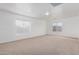 Spacious living room featuring plush carpeting, bright windows, and neutral paint at 22672 W Solano Dr, Buckeye, AZ 85326