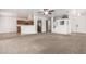 Open living space with carpet and tile flooring, connecting the living area to the kitchen at 22672 W Solano Dr, Buckeye, AZ 85326