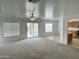 Bright living room featuring carpeted floors, multiple windows, and access to the backyard pool at 22672 W Solano Dr, Buckeye, AZ 85326