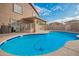 Outdoor pool with surrounding patio, complemented by landscaping and mature plants at 22672 W Solano Dr, Buckeye, AZ 85326