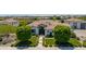 Aerial view showcasing the landscaped front yard with manicured bushes and mature trees at 24372 N 96Th Ln, Peoria, AZ 85383