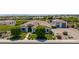 Aerial view of the property featuring a well-maintained home, a lush lawn, and meticulous landscaping at 24372 N 96Th Ln, Peoria, AZ 85383
