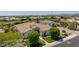 A high-angle view of the estate, highlighting its well-manicured lawn and lush surrounding greenery at 24372 N 96Th Ln, Peoria, AZ 85383