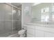 Neutral bathroom featuring sleek shower with glass doors and white cabinets at 24372 N 96Th Ln, Peoria, AZ 85383
