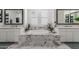 Bright bathroom showcasing a luxurious soaking tub surrounded by marble and dual vanities at 24372 N 96Th Ln, Peoria, AZ 85383