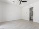 Spacious, airy bedroom with sleek flooring, ceiling fan, and modern lighting at 24372 N 96Th Ln, Peoria, AZ 85383