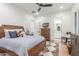 Comfortable bedroom with ceiling fan includes an ensuite bathroom and closet at 24372 N 96Th Ln, Peoria, AZ 85383
