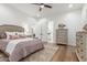 Bedroom with ample natural light has neutral walls, ceiling fan, and an ensuite bath at 24372 N 96Th Ln, Peoria, AZ 85383
