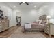 Comfortable bedroom with a ceiling fan, closet, and dressers for ample storage at 24372 N 96Th Ln, Peoria, AZ 85383