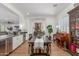 Open dining room showcasing seamless access to kitchen and living areas with hardwood floors at 24372 N 96Th Ln, Peoria, AZ 85383