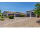 Spacious driveway providing ample parking and access to the multiple garages, surrounded by desert landscaping at 24372 N 96Th Ln, Peoria, AZ 85383
