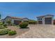 Large driveway provides ample parking space and leads to multiple garages, with desert landscaping at 24372 N 96Th Ln, Peoria, AZ 85383