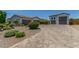 Expansive driveway leading to multiple garages, complemented by desert landscaping and mature trees at 24372 N 96Th Ln, Peoria, AZ 85383