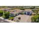 Elegant desert home with a sprawling driveway, manicured landscaping, and a separate garage at 24372 N 96Th Ln, Peoria, AZ 85383