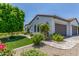 Beautiful home exterior featuring a well-manicured lawn, mature trees, and a detached garage with ample parking at 24372 N 96Th Ln, Peoria, AZ 85383