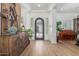 Elegant foyer with wood floors, decorative furnishings, and a view of the front courtyard at 24372 N 96Th Ln, Peoria, AZ 85383
