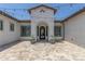 Inviting front entrance featuring a beautifully tiled courtyard and decorative wrought iron door at 24372 N 96Th Ln, Peoria, AZ 85383