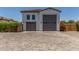 Two-car garage with an extended paved driveway, offering ample parking, and neat landscaping at 24372 N 96Th Ln, Peoria, AZ 85383