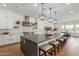 Modern kitchen with a large island, stainless steel appliances, and stylish pendant lighting creating a culinary haven at 24372 N 96Th Ln, Peoria, AZ 85383