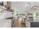 Spacious kitchen with white cabinets, stainless steel appliances, and a large center island, great for cooking and entertaining at 24372 N 96Th Ln, Peoria, AZ 85383