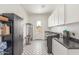 Well-lit laundry room with patterned floors, modern washer and dryer, and ample cabinet space for storage at 24372 N 96Th Ln, Peoria, AZ 85383
