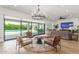 Inviting living room with seating, a view of the pool, and access to outdoor living spaces, perfect for indoor/outdoor living at 24372 N 96Th Ln, Peoria, AZ 85383