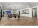 Spacious living room featuring ample seating, hardwood floors, and an open layout, ideal for entertaining guests at 24372 N 96Th Ln, Peoria, AZ 85383
