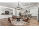 Open floor plan showcasing a living room area with a chandelier and easy access to the kitchen and dining spaces at 24372 N 96Th Ln, Peoria, AZ 85383