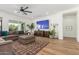 Bright living room with comfortable seating, stylish rug, and modern ceiling fan, perfect for relaxing and entertaining at 24372 N 96Th Ln, Peoria, AZ 85383