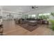 Open-concept living room featuring a spacious seating area, hardwood floors, and seamless flow to the kitchen at 24372 N 96Th Ln, Peoria, AZ 85383