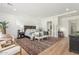 Spacious main bedroom with a cozy sitting area, decorative rug, and ample natural light at 24372 N 96Th Ln, Peoria, AZ 85383