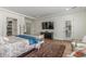 Well-lit main bedroom featuring a media center, closet, and access to the backyard at 24372 N 96Th Ln, Peoria, AZ 85383