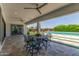 Covered patio with outdoor seating and views of the pool and beautifully landscaped yard at 24372 N 96Th Ln, Peoria, AZ 85383