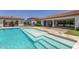 Stunning pool with shallow lounging area and lush landscaping, perfect for relaxation and entertainment at 24372 N 96Th Ln, Peoria, AZ 85383