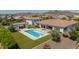 Inviting backyard with a sparkling pool, covered patio, and lush landscaping, creating a private retreat at 24372 N 96Th Ln, Peoria, AZ 85383