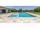 Sparkling pool with spa and travertine surround, surrounded by mature landscaping at 24372 N 96Th Ln, Peoria, AZ 85383