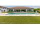 Inviting backyard pool featuring a shallow sunbathing ledge and lush synthetic grass at 24372 N 96Th Ln, Peoria, AZ 85383