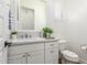 A clean powder room features a white vanity, large mirror, and bright natural light at 24372 N 96Th Ln, Peoria, AZ 85383